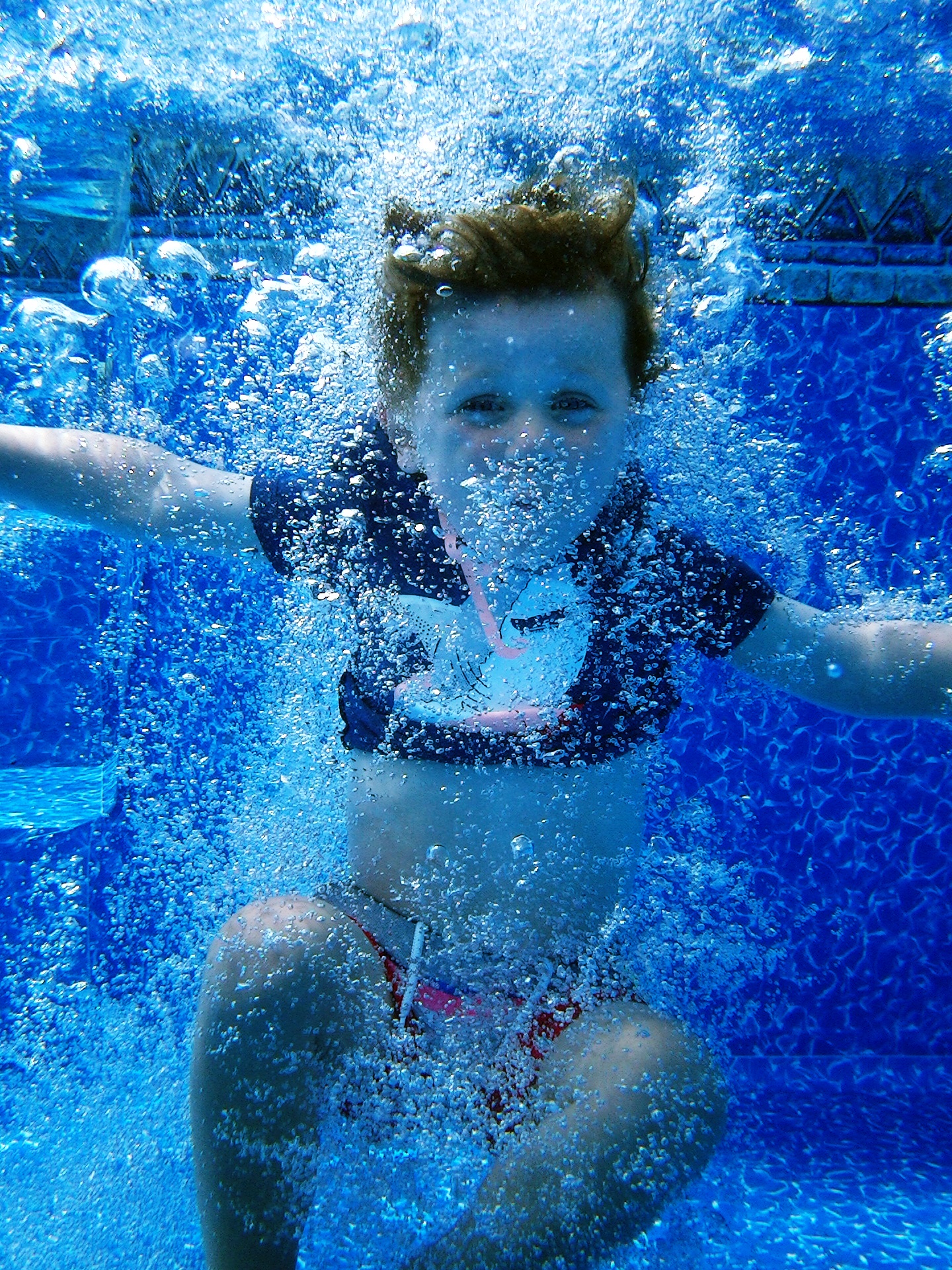 my son jumping in the pool